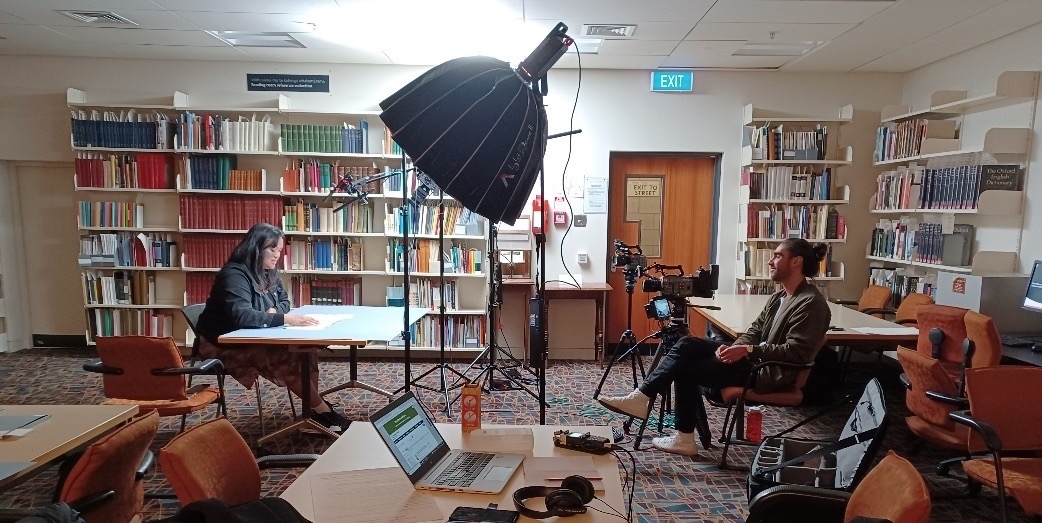 Nia Vavao and Benjamin Brooking filming Following the Moon – Pacific Lunar Calendars, 2023, Auckland Central Library Heritage Collections Reading Room, photograph by Sue Berman